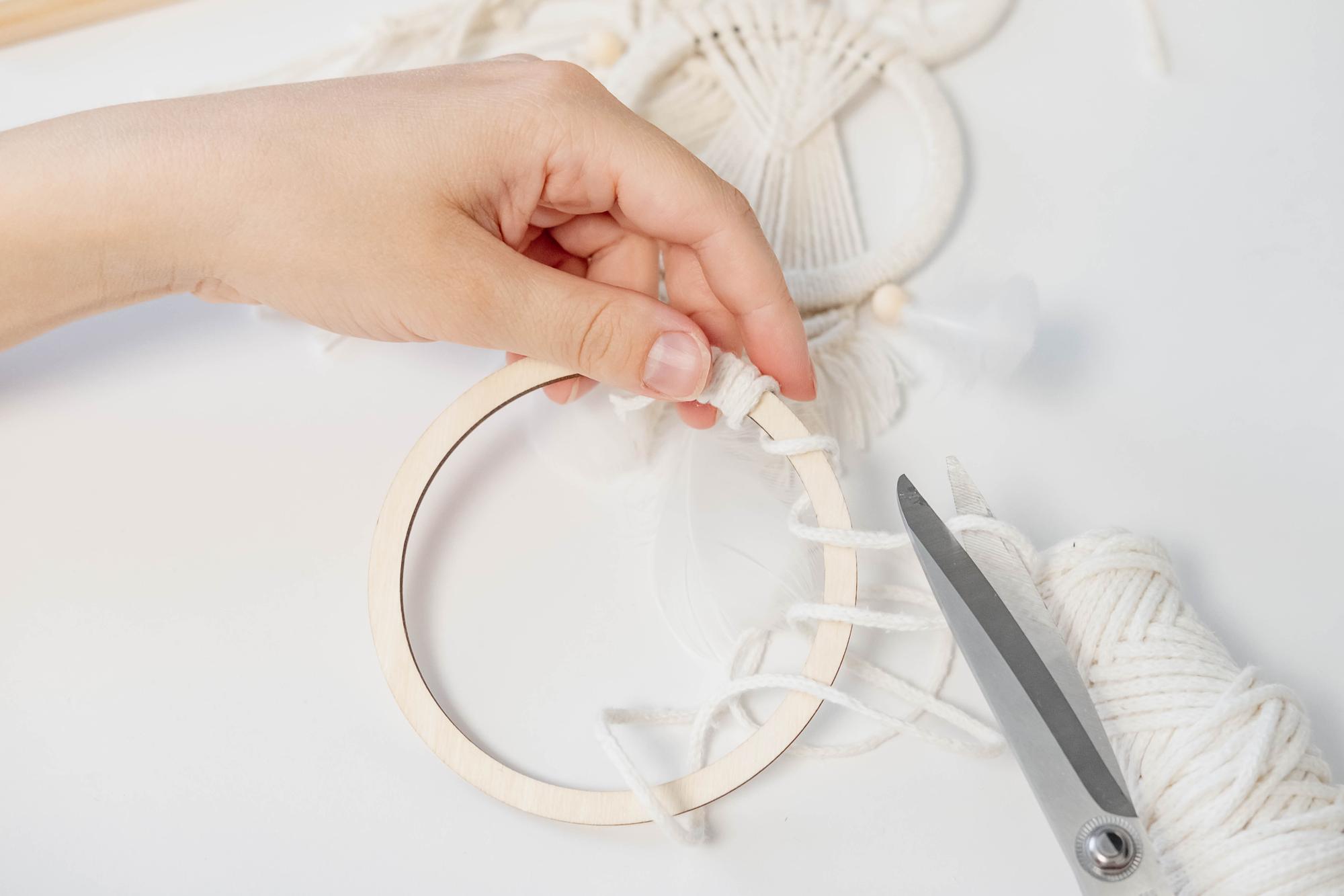 Hands working on embroidery hoop